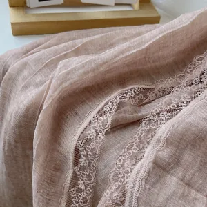 Detailed macro view of soft rose pink cotton scarf featuring exquisite eyelash lace trim