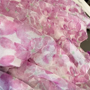 Detailed macro view of lightweight floral scarf fabric showing semi-transparent linen texture
