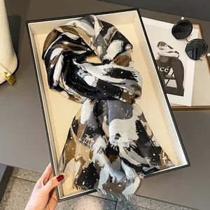 Detailed view of abstract ink painting print on linen cotton scarf with raw fringe edges