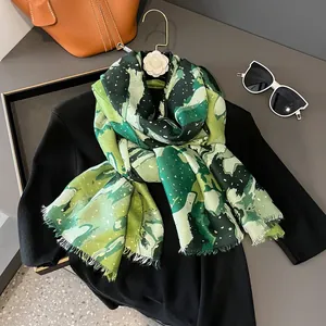 Detail of green linen cotton scarf with oil painting print and gold glitter on black knit