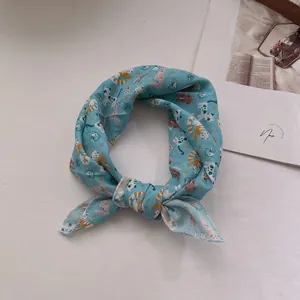 Sky blue cotton linen bandana with cute cartoon cat pattern tied in a stylish knot