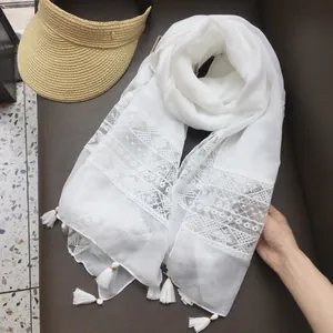 White bohemian lace shawl scarf with tassel trim and geometric patterns for summer beach