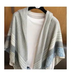 Close-up of grey plaid scarf with fine geometric texture and elegant fringe edges
