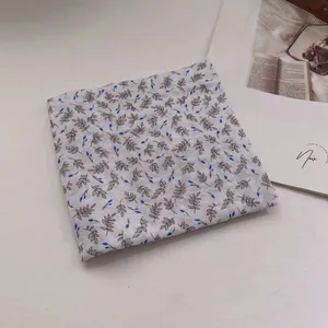 Detail of folded linen cotton bandana featuring vintage floral cashew branch patterns