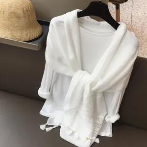 White ethnic lace scarf with embroidery and fringe detail for beach vacation travel outfits