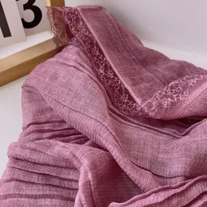 Detailed view of mauve cotton linen scarf featuring delicate lace edges and textured fabric