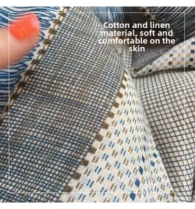 Macro detail of cotton and linen fabric with blue, brown, and white checkered pattern