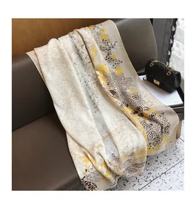 Close-up of elegant floral print scarf showing soft texture and premium leaf patterns