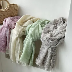 Long textured linen scarves in soft floral purple, cream, and green with fringe detail