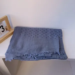 Detail of grey-blue linen scarf with black polka dots and fringe edge decoration