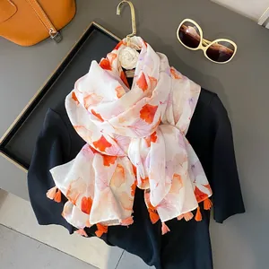 Floral print scarf with orange tassels and ginkgo leaf pattern for summer sun protection