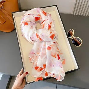 Elegant white floral ginkgo leaf print shawl with tassels and orange accessories