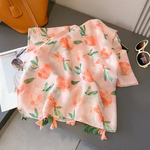 Pink linen-feel scarf with peach prints and dual-color tassels for summer sun protection