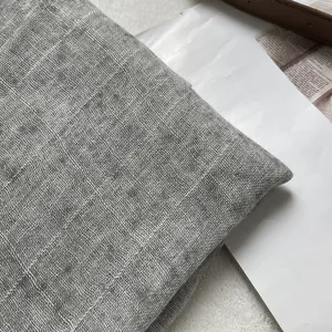 Close-up detail of grey textured linen blend fabric showing natural weave and thick texture