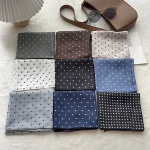 Nine colors of vintage polka dot cotton scarves displayed on a stylish creative background