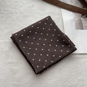 Elegant dark brown polka dot cotton scarf on a soft white background for women