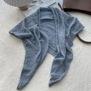 Detailed macro view of the grey blue pleated fabric with white wavy stitched edges