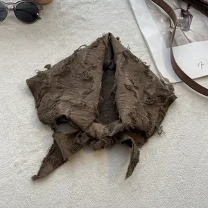 Close-up of a vintage dark brown cotton linen triangle scarf with raw frayed edges