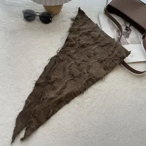 Detail of coffee brown cotton linen neckerchief with raw edges and wrinkled texture