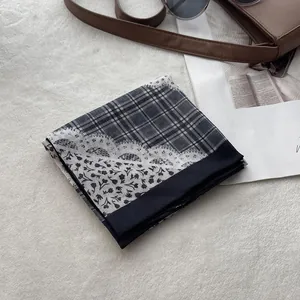 Detail of floral cotton linen square scarf with plaid and lace pattern on plush background
