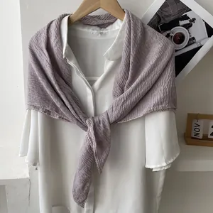 Detail of lavender pleated cotton scarf featuring delicate hollowed scalloped lace edges