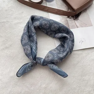Close-up of retro navy blue patterned cotton linen scarf on a soft white texture background