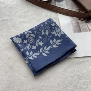 Detail of blue floral cotton linen square scarf with white botanical pattern print