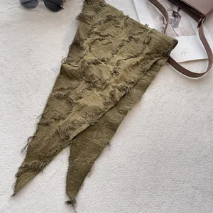 Detail of olive green textured cotton linen triangle scarf with frayed raw edges