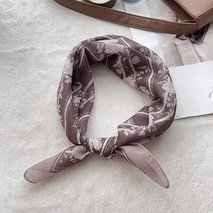 Detailed view of paisley cotton bandana in dusty rose with floral patterns and rolled edge