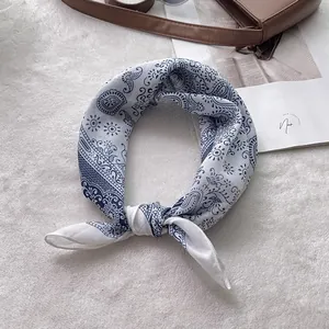 Detailed view of paisley cotton linen scarf tied elegantly on a designer handbag