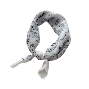Classic white cotton paisley bandana with black floral print shown in a tied loop style