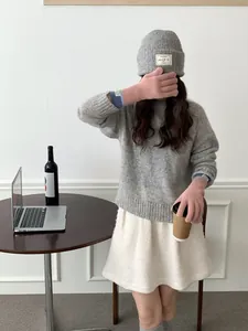 Detail of pink and blue ribbed knit long arm warmers paired with a cozy grey winter sweater