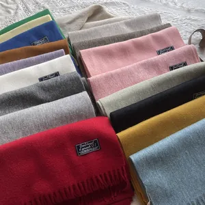 Close-up detail of soft wool tassels and diverse color options for high-quality winter scarves