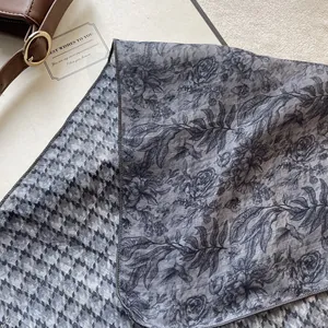 French style floral and houndstooth cotton linen scarf displayed with a leather handbag