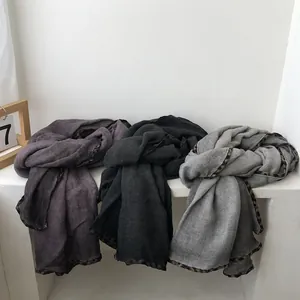 Detail of scarves in purple, black, and grey with chic leopard print trim on fabric