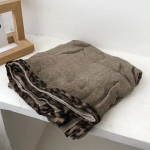 Close-up of brown cotton linen scarf featuring stylish leopard print edge detailing