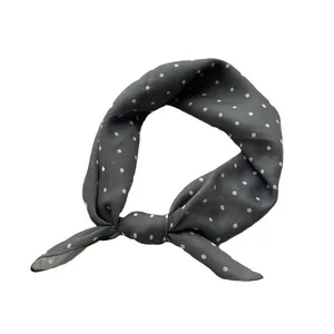 Classic charcoal grey polka dot silk scarf tied in a stylish knot for women
