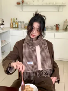 Detail showing high-quality wool fibers of the coffee plaid scarf with fine fringe edges