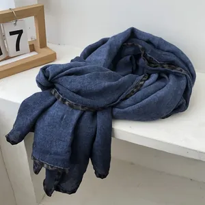 Detail of navy blue scarf featuring a stylish leopard print trim on premium textured fabric