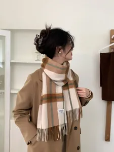 Detailed view of hazel cashmere scarf with plaid pattern and long tassel fringe details