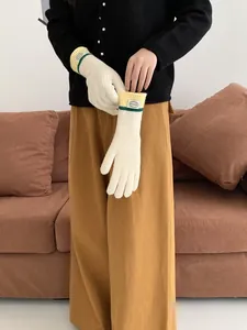 Detail of knitted touchscreen gloves showing ribbed texture and contrast wrist trim