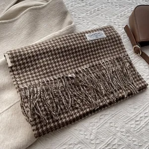 Close-up of retro houndstooth wool scarf with fringe edge and brand woven label