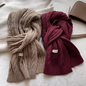 Detailed cable knit texture of high-quality wool winter scarves in brown and burgundy