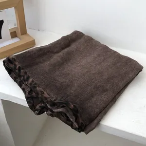 Close-up of a brown towel with leopard print trim made of absorbent terry cloth fabric