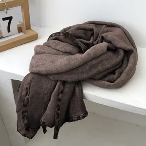 Detailed close-up of dark coffee cotton linen scarf with leopard print borders