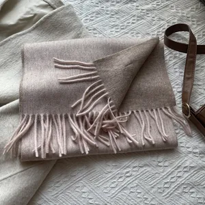 Close-up of pink 100% wool scarf with soft fringe tassels and high density weave
