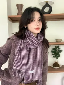 Detail view of purple houndstooth wool scarf with fringe and soft knitted sweater