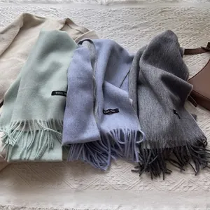 100% Wool scarves with tassels in mint green, light blue, and grey for winter warmth