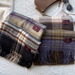Flat lay of plaid tassel scarves in various colors with retro fashion accessories