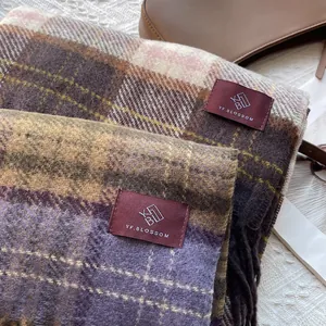 Detail of warm retro plaid scarves with fringed edges and soft woolly texture